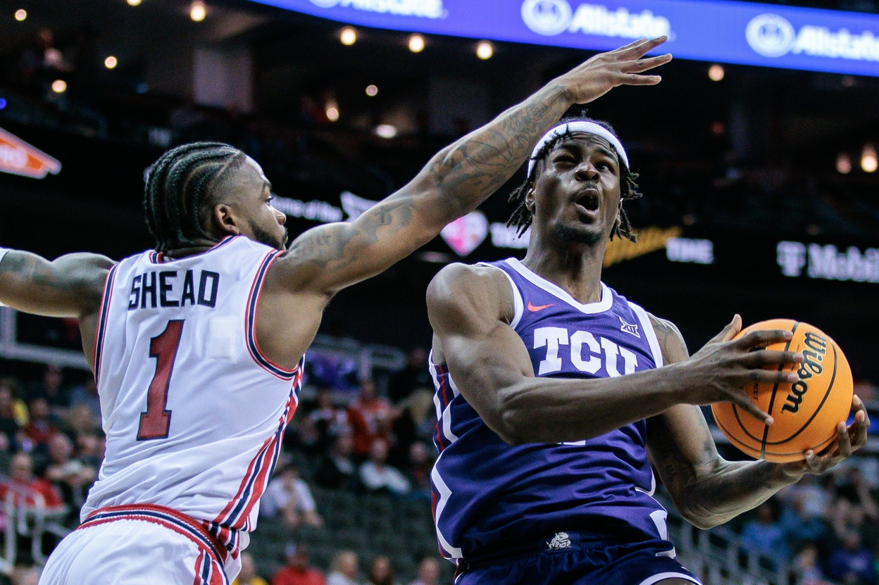 Mar 14, 2024; Kansas City, MO, USA; TCU Horned Frogs forward Emanuel Miller (2) shoots the ball around Houston Cougars guard Jamal Shead (1) during the second half at T-Mobile Center. M