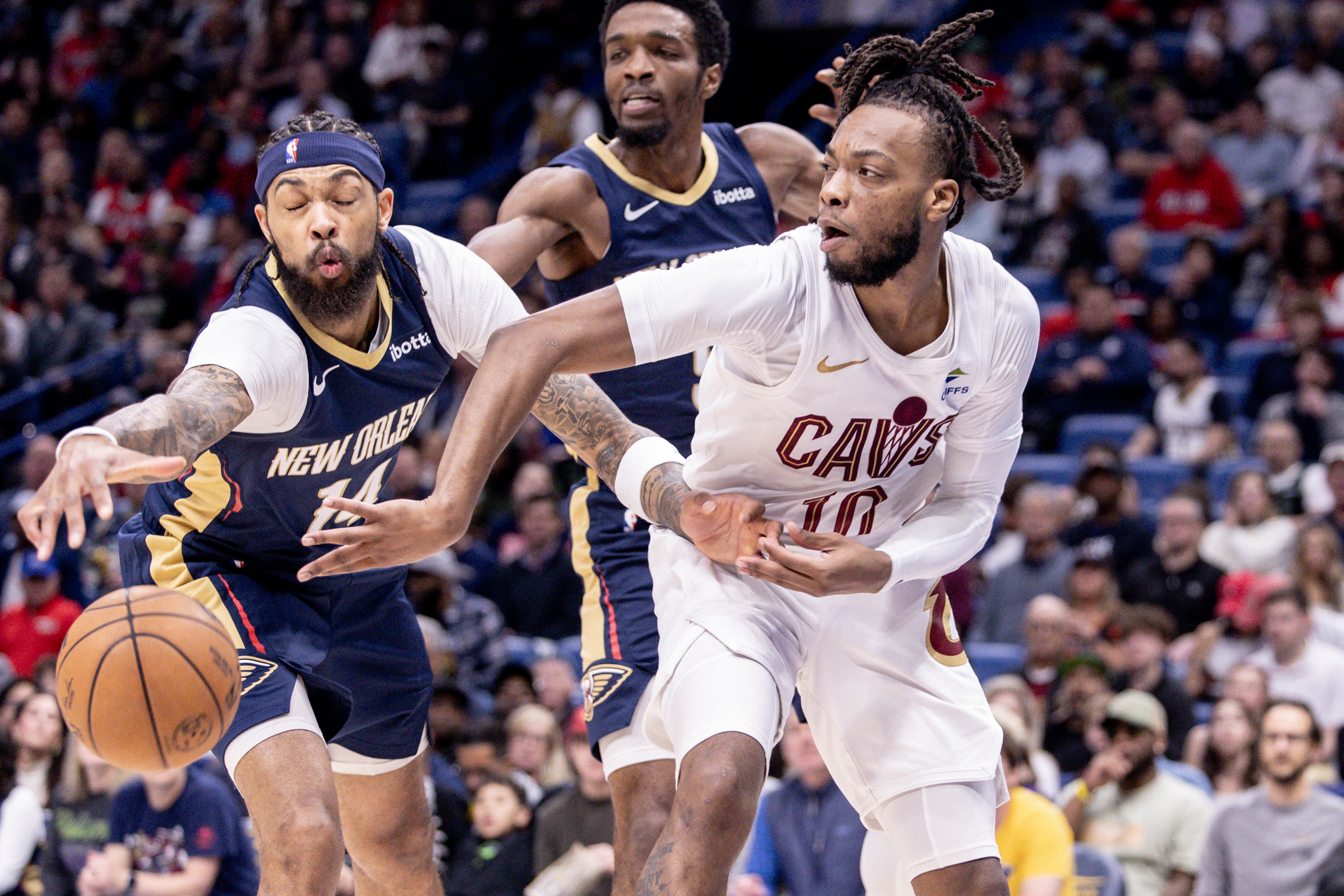 Mar 13, 2024; New Orleans, Louisiana, USA; Cleveland Cavaliers guard Darius Garland (10) looks to pass the ball against New Orleans Pelicans forward Brandon Ingram (14) during the first half at Smoothie King Center.