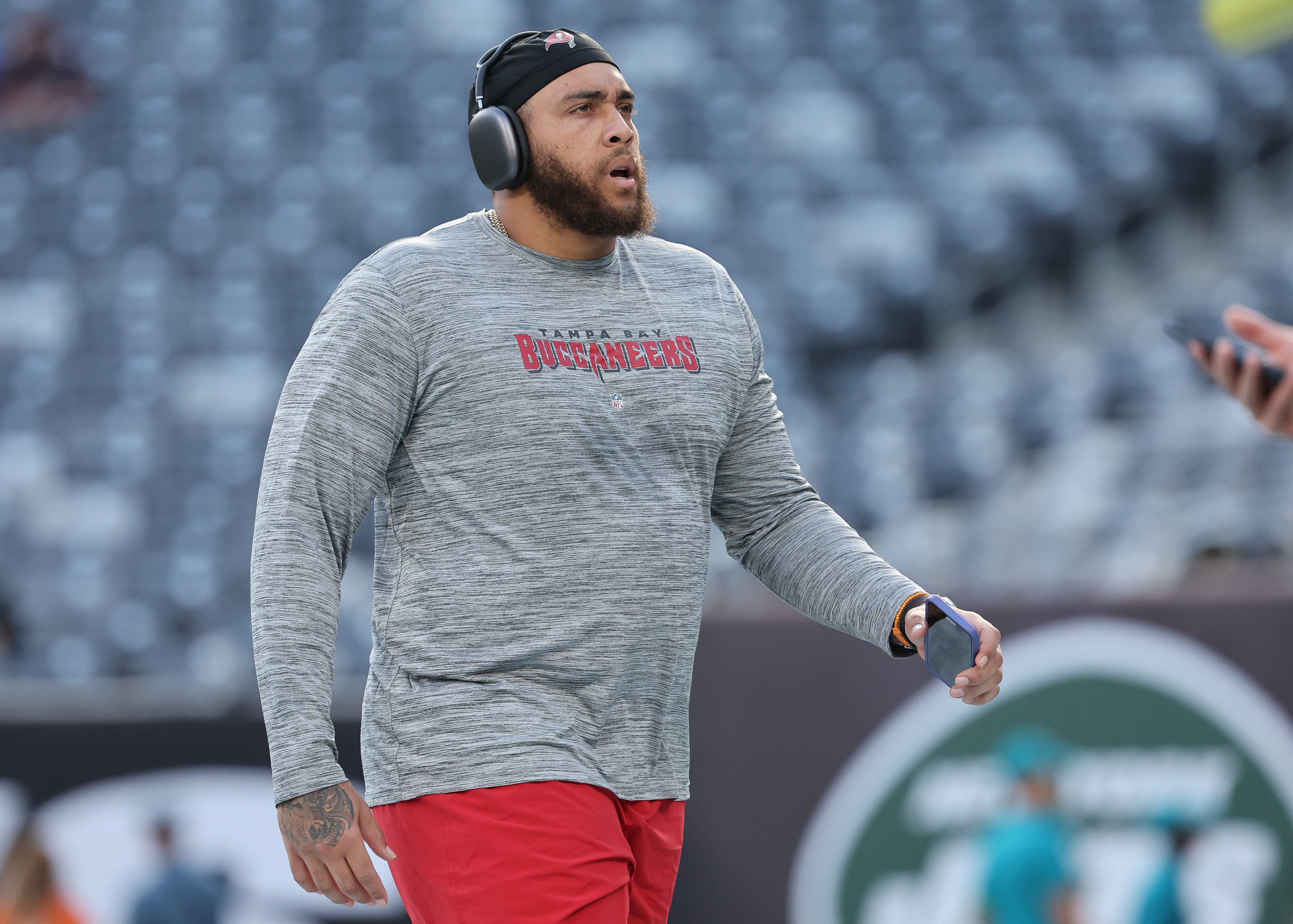 Aug 19, 2023; East Rutherford, New Jersey, USA; Tampa Bay Buccaneers guard Aaron Stinnie (64) warms up before the game against the New York Jets at MetLife Stadium.