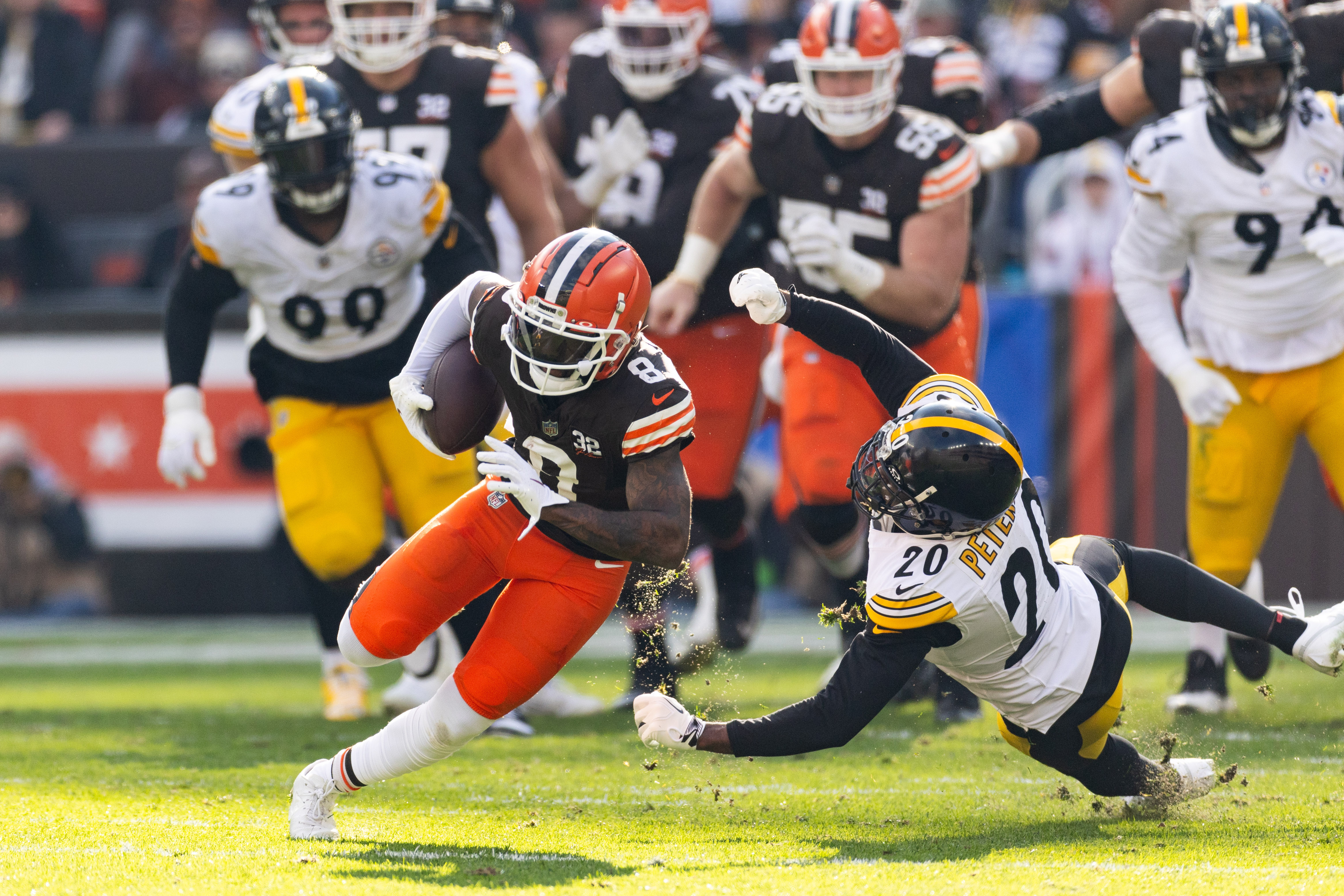 Nov 19, 2023; Cleveland, Ohio, USA; Cleveland Browns wide receiver Elijah Moore (8) runs the ball past Pittsburgh Steelers cornerback Patrick Peterson (20) during the second quarter at Cleveland Browns Stadium. Mandatory Credit: Scott Galvin-USA TODAY Sports  