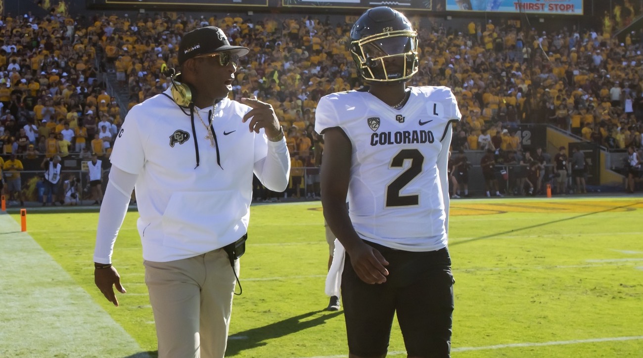 Colorado Buffaloes coach Deion Sanders with son and quarterback Shedeur Sanders (2) against the Arizona State Sun Devils at Mountain America Stadium.