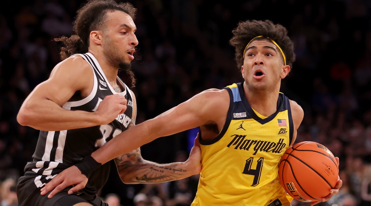 Marquette Golden Eagles guard Stevie Mitchell (4) drives to the basket against Providence Friars guard Devin Carter (22) during the second half at Madison Square Garden in New York City on March 15, 2024.