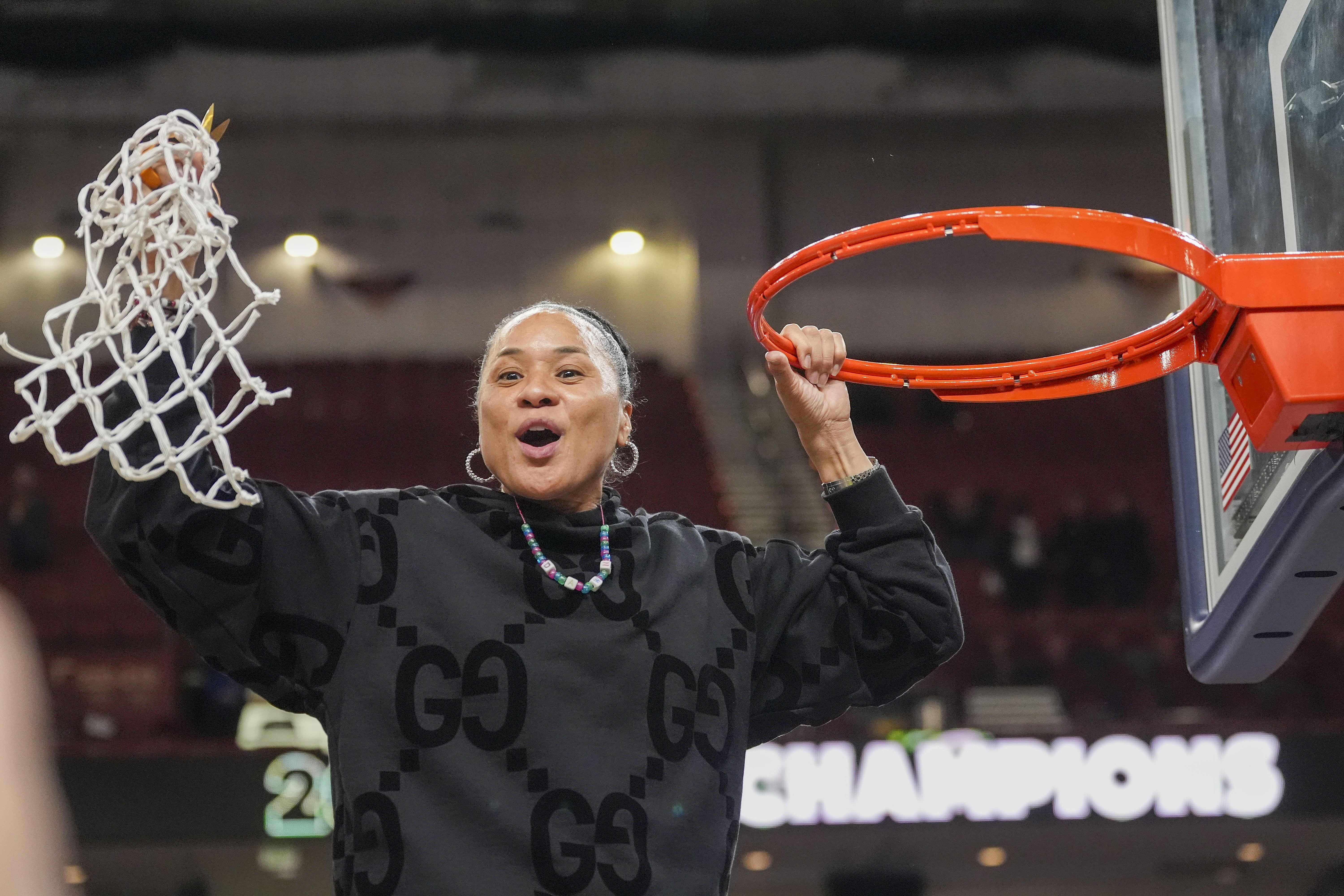 South Carolina head coach Dawn Staley cuts the net after winning the SEC championship over LSU.