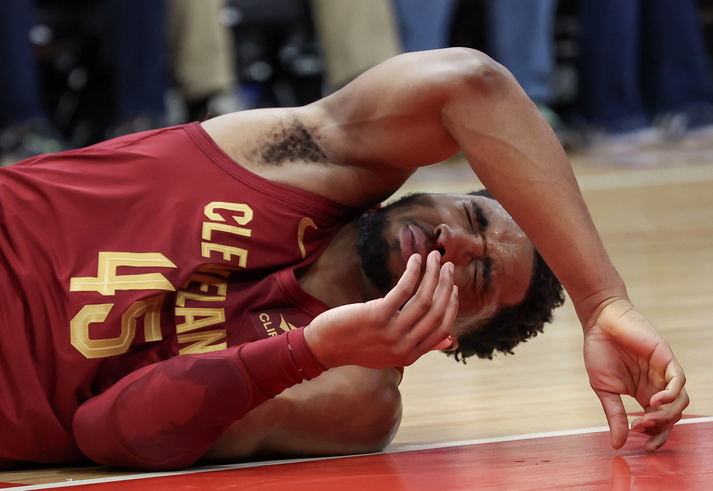 Cleveland Cavaliers guard Donovan Mitchell (45) reacts after teammate Tristan Thompson hit him in the nose with his elbow 