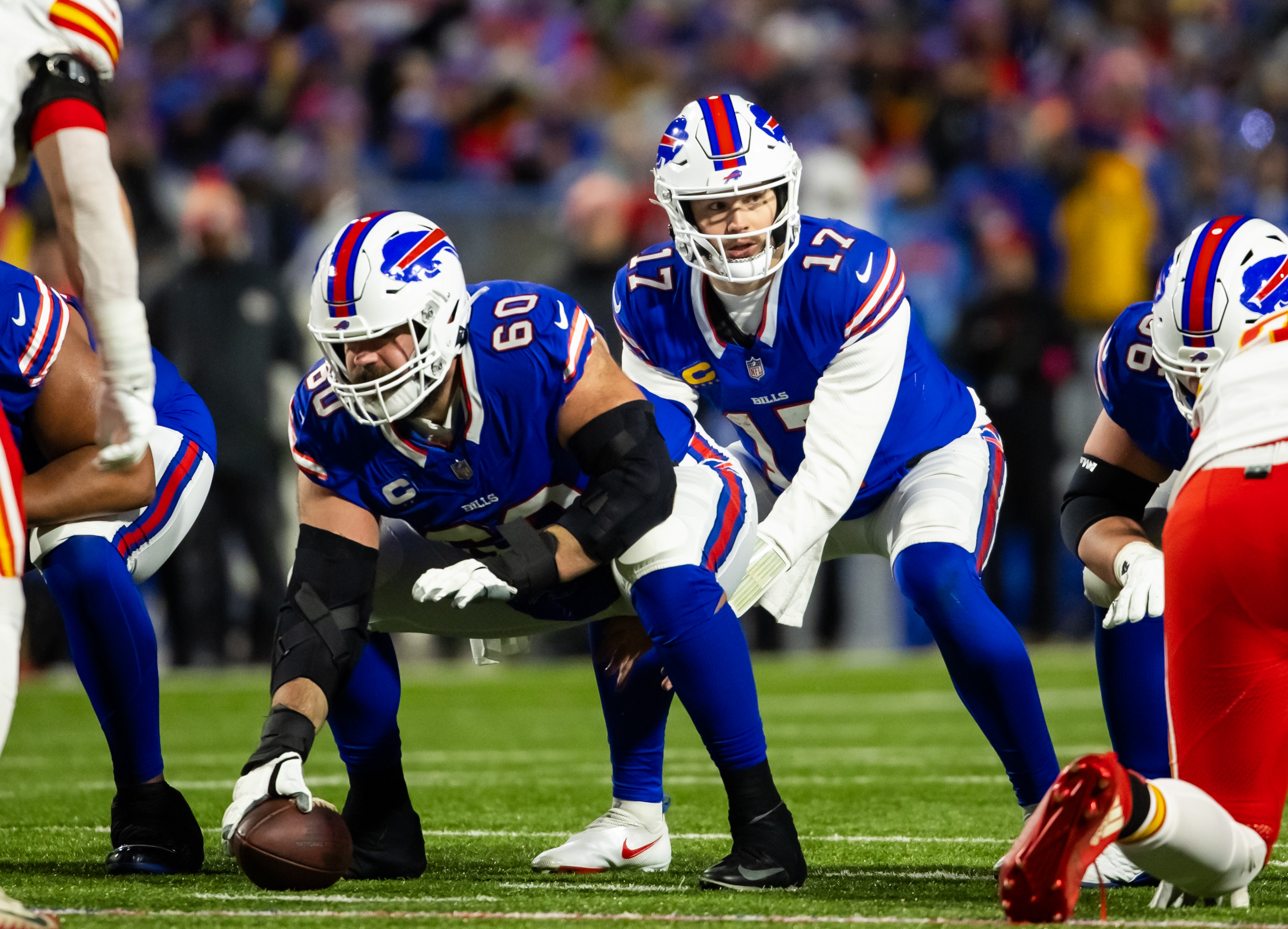 Mitch Morse bends over to snap the ball to Josh Allen