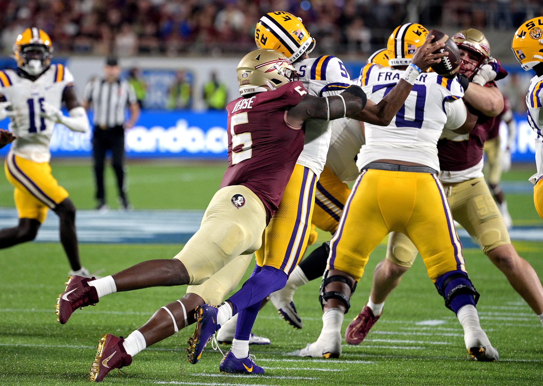 LSU Tigers quarterback Jayden Daniels (5) is sacked by Florida State Seminoles defensive end Jared Verse (5). Mandatory Credit: Melina Myers-USA TODAY Sports
