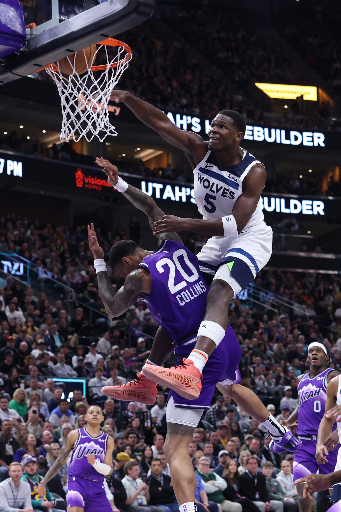 Mar 18, 2024; Salt Lake City, Utah, USA; Minnesota Timberwolves guard Anthony Edwards (5) dunks the ball against Utah Jazz forward John Collins (20) during the third quarter at Delta Center.