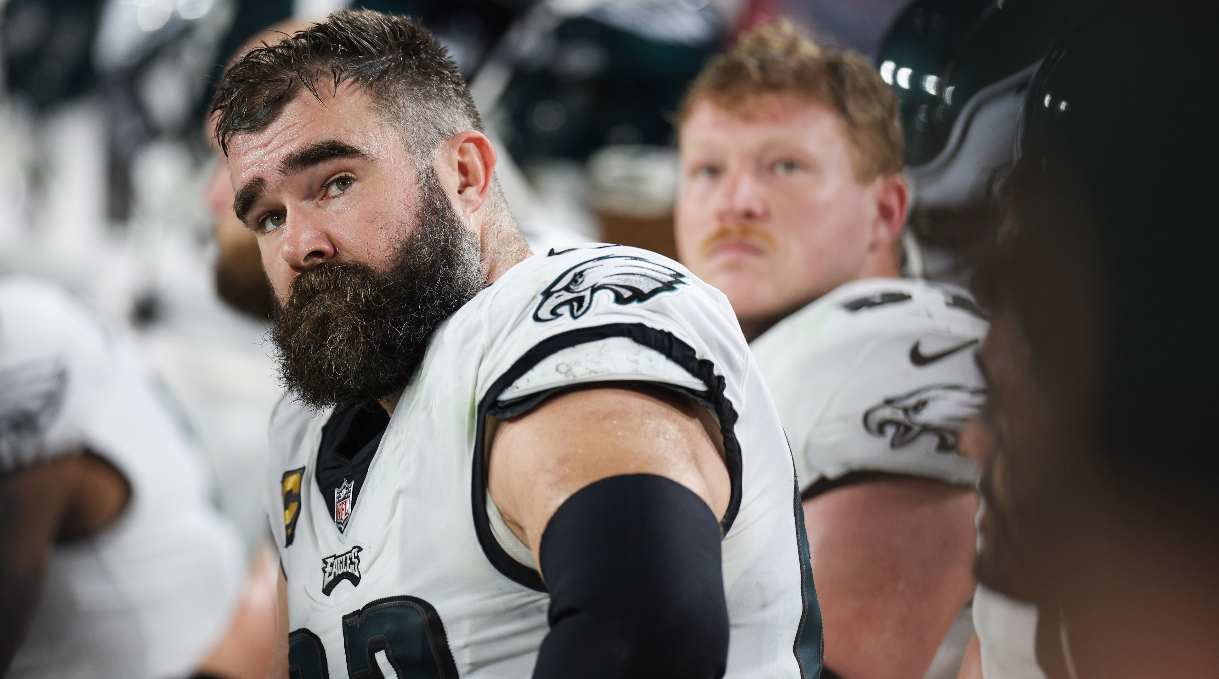 Jason Kelce looks over his shoulder as he sits down in an Eagles uniform