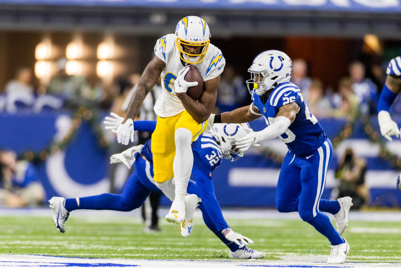 Dec 26, 2022; Indianapolis, Indiana, USA; Los Angeles Chargers wide receiver Mike Williams (81) runs the ball while Indianapolis Colts safety Rodney Thomas II (25) defends in the second half at Lucas Oil Stadium.