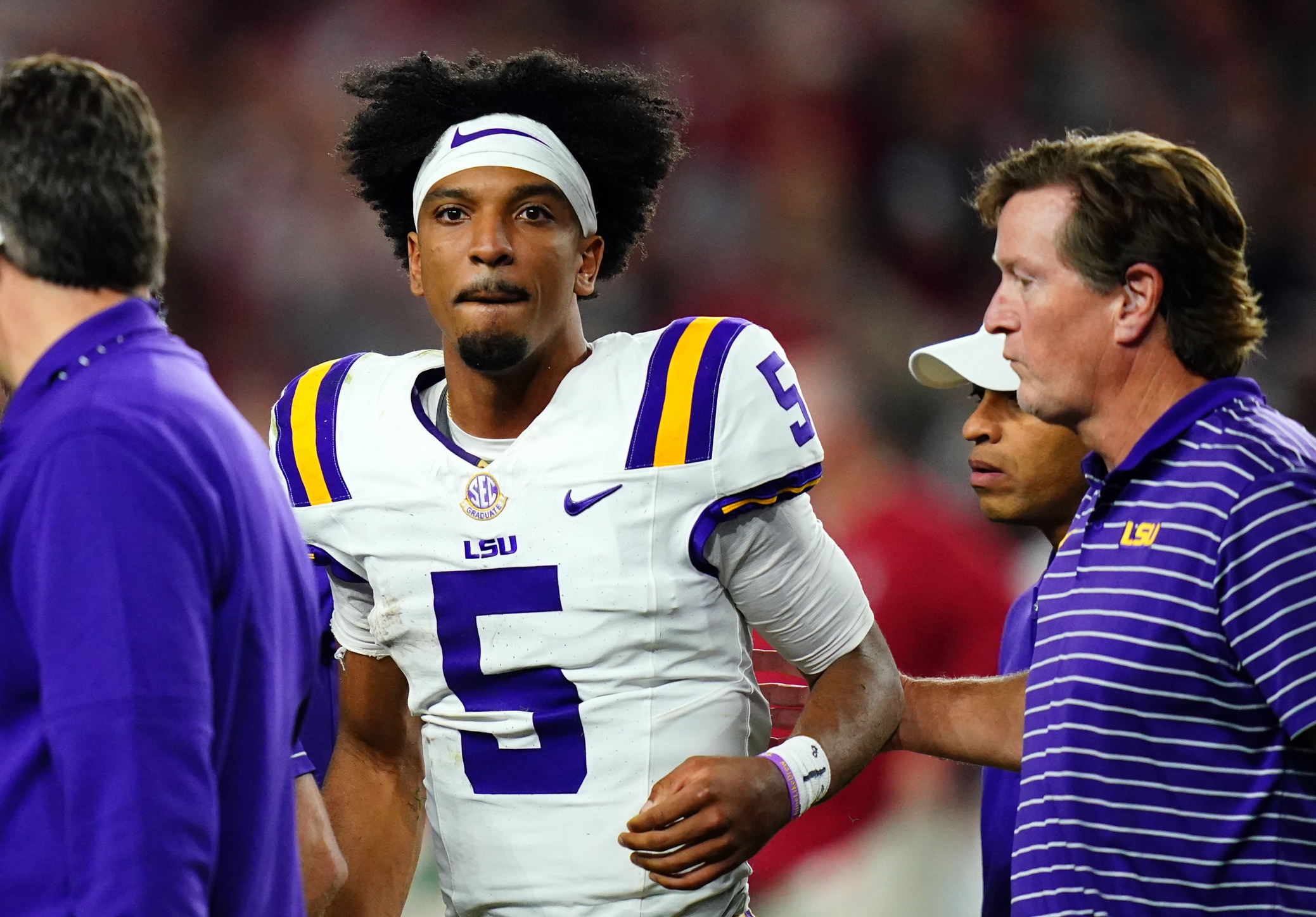 Nov 4, 2023; Tuscaloosa, Alabama, USA; LSU Tigers quarterback Jayden Daniels (5) is helped off the field with trainers and medical staff after being hit by the Alabama Crimson Tide defense during the second half at Bryant-Denny Stadium. After review Alabama was penalized with roughing the passer.