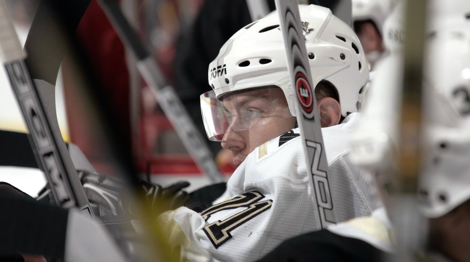 Former Penguins winger Konstantin Koltsov looks on from the bench during a game.