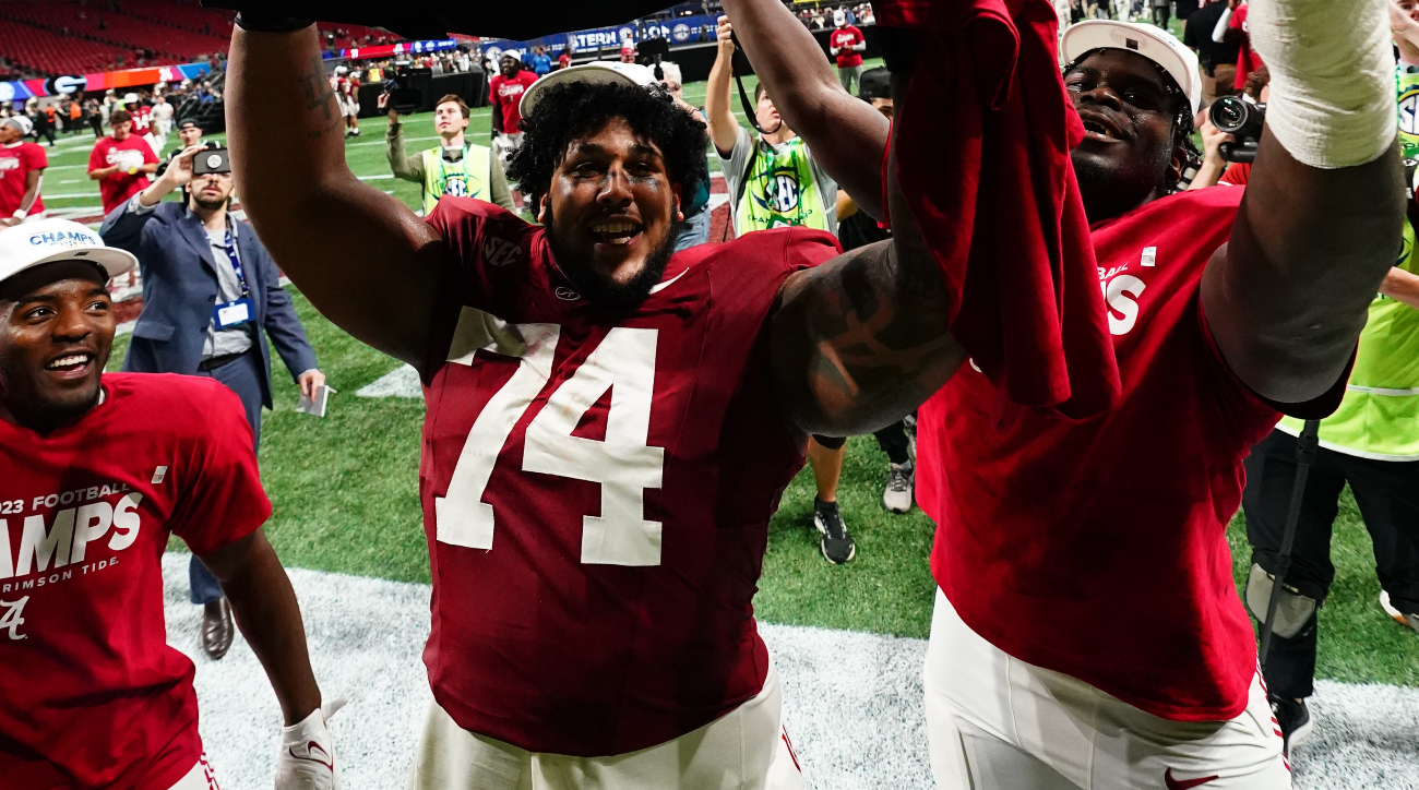 Dec 2, 2023; Atlanta, GA, USA; Alabama Crimson Tide offensive lineman Kadyn Proctor (74) celebrates with the trophy after defeating the Georgia Bulldogs in the SEC Championship at Mercedes-Benz Stadium.