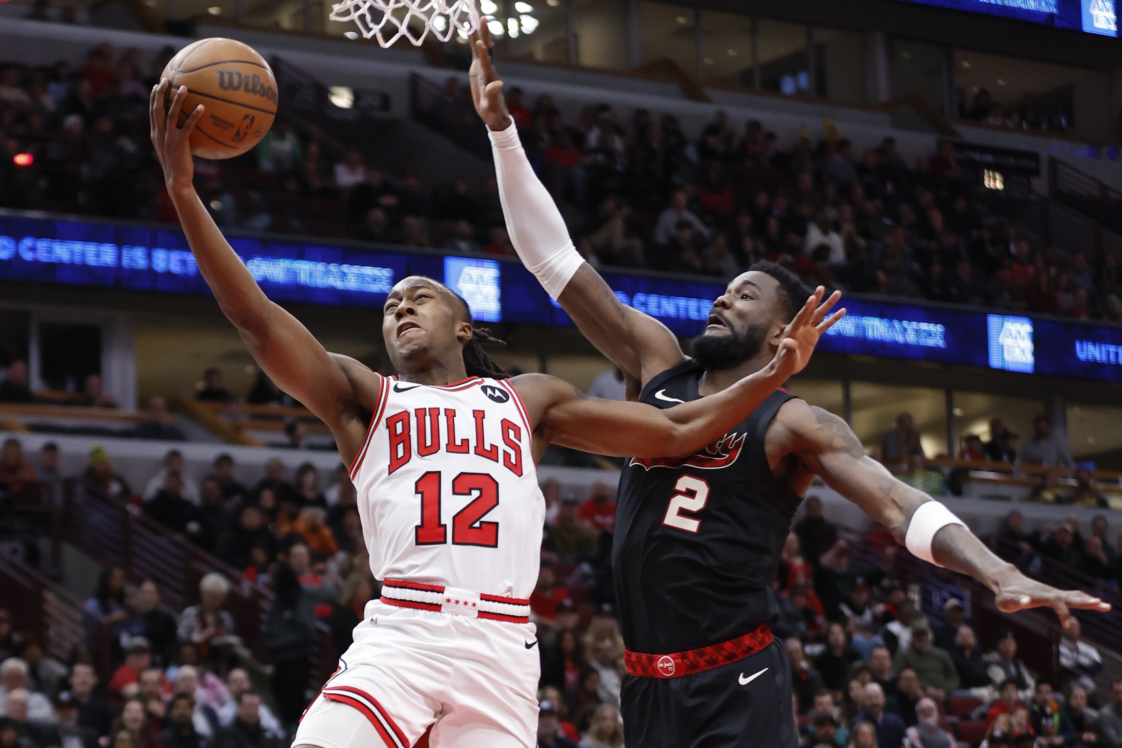 Chicago Bulls guard Ayo Dosunmu (12) goes to the basket against Portland Trail Blazers center Deandre Ayton (2) during the first half at United Center.