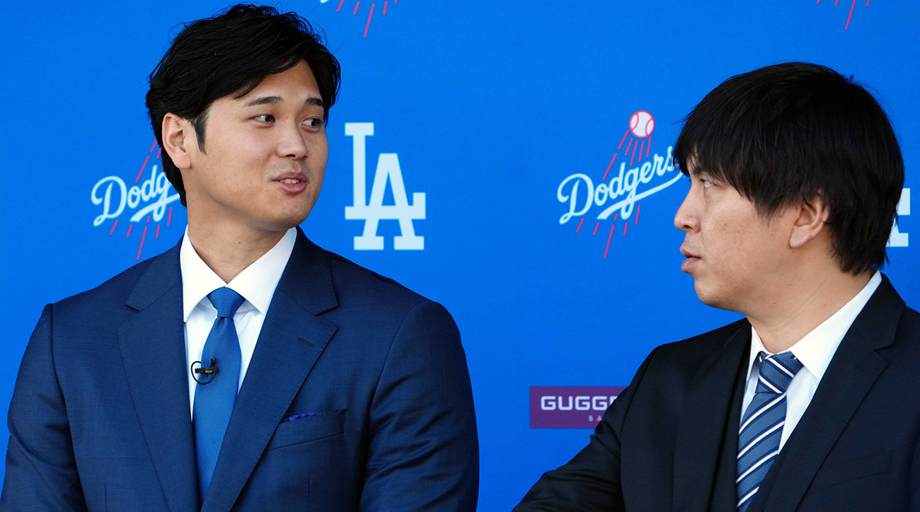Los Angeles Dodgers designated hitter Shohei Ohtani speaks to interpreter Ippei Mizuhara at an introductory press conference.
