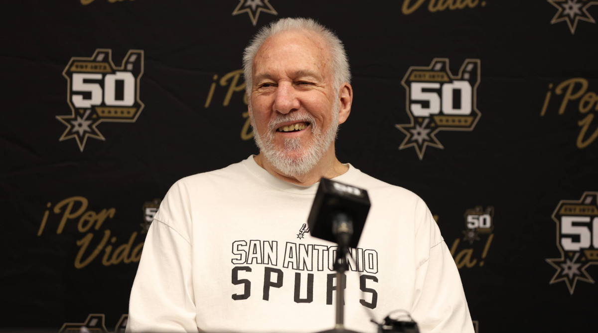 San Antonio Spurs head coach Gregg Popovich smiles while speaking to the media.