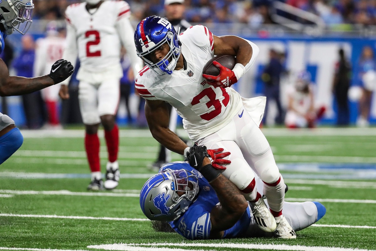 New York Giants running back Matt Breida (31) is stopped by Detroit Lions linebacker Derrick Barnes (55) during the first half of a preseason game at Ford Field in Detroit on Friday, Aug. 11, 2023.