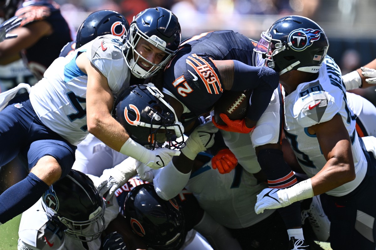 Chicago Bears running back D'Onta Foreman (21) is tackled up by Tennessee Titans linebacker Ben Niemann (47), left and outside linebacker Rashad Weaver (99) in the first half at Soldier Field.