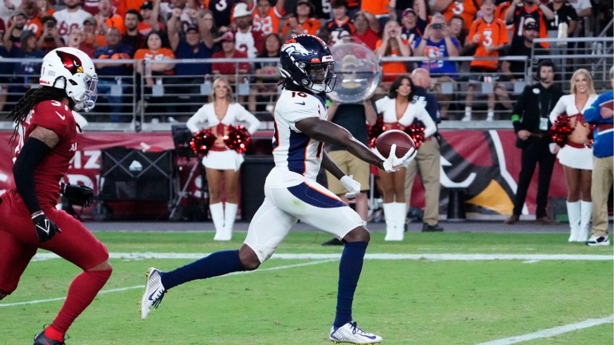 Denver Broncos wide receiver Jerry Jeudy (10) scores a touchdown past Arizona Cardinals safety Andre Chachere (31) during a preseason game at State Farm Stadium in Glendale on Aug. 11, 2023.  