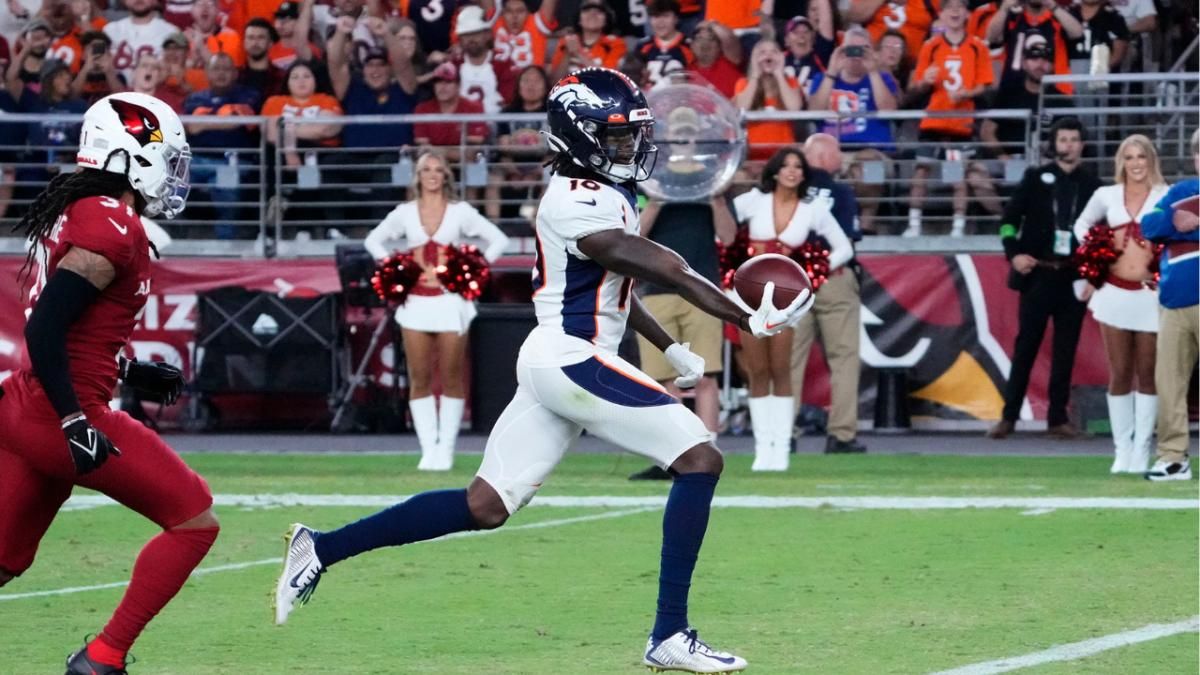 Denver Broncos wide receiver Jerry Jeudy (10) scores a touchdown past Arizona Cardinals safety Andre Chachere (31) during a preseason game at State Farm Stadium in Glendale on Aug. 11, 2023.