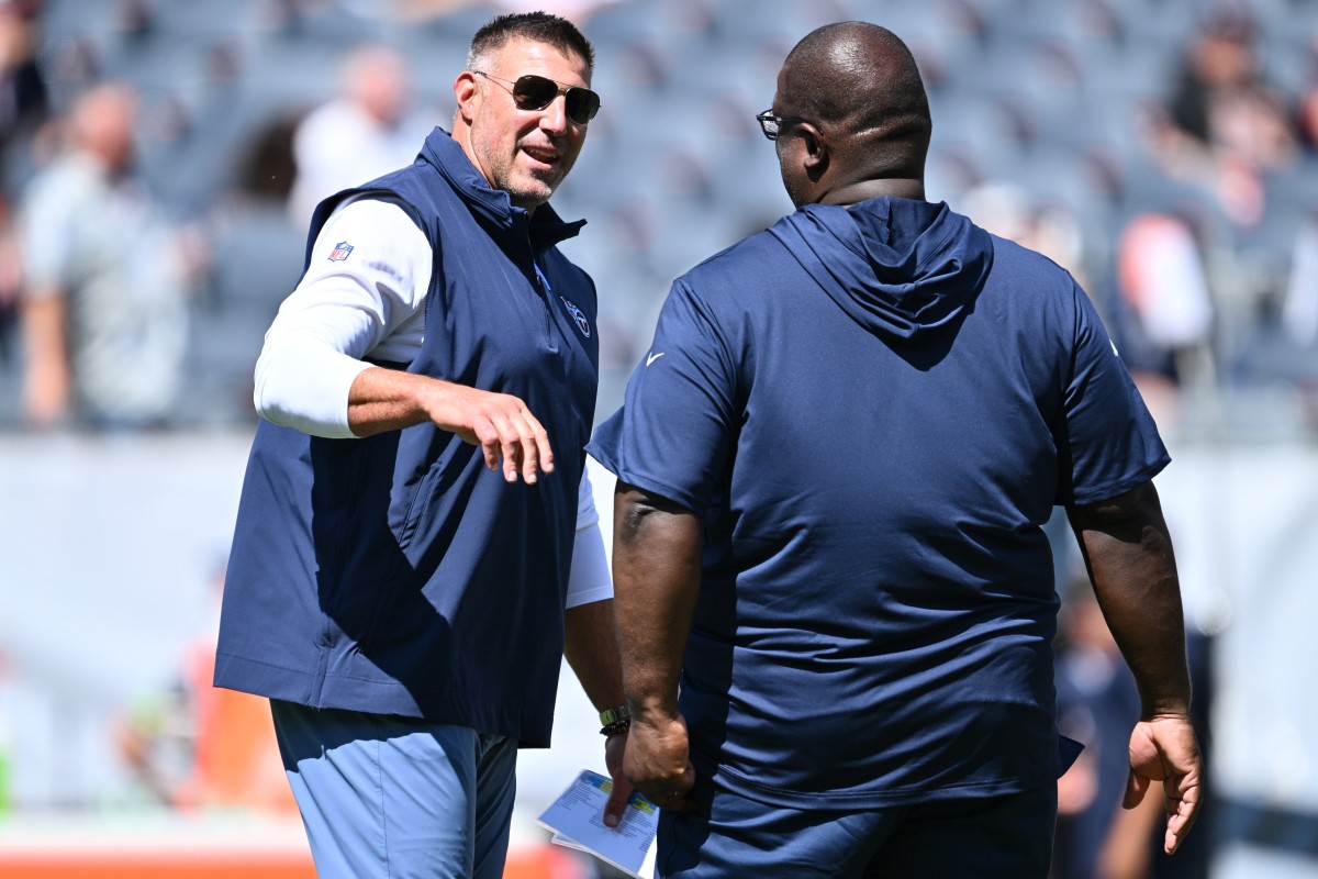 Tennessee Titans Head Coach Mike Vrabel talks with Assistant Head Coach Terrell Williams before a game against the Chicago Bears at Soldier Field.