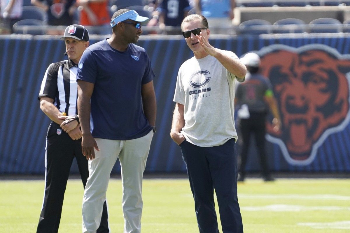Chicago Bears head coach Matt Eberflus (right) talks with a member of the Tennessee Titans coaching staff before the game at Soldier Field.