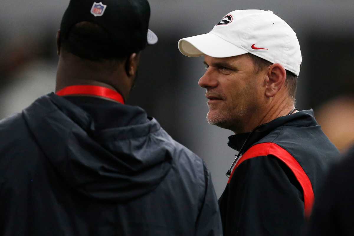 Georgia football analyst Mike Bobo speaks with an NFL scout during Georgia's Pro Day in Athens, Ga., on Wednesday, March 16, 2022. News Joshua L Jones