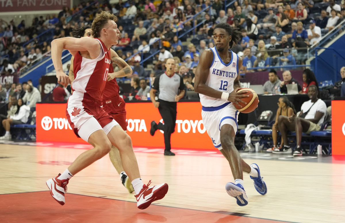 Jul 16, 2023; Toronto, Ontario, Canada; USA-Kentucky guard Antonio Reeves (12) drives to the net against Canada forward Adam Paige (17) during the first half of the Men's Gold game at Mattamy Athletic Centre. Mandatory Credit: John E. Sokolowski-USA TODAY Sports  