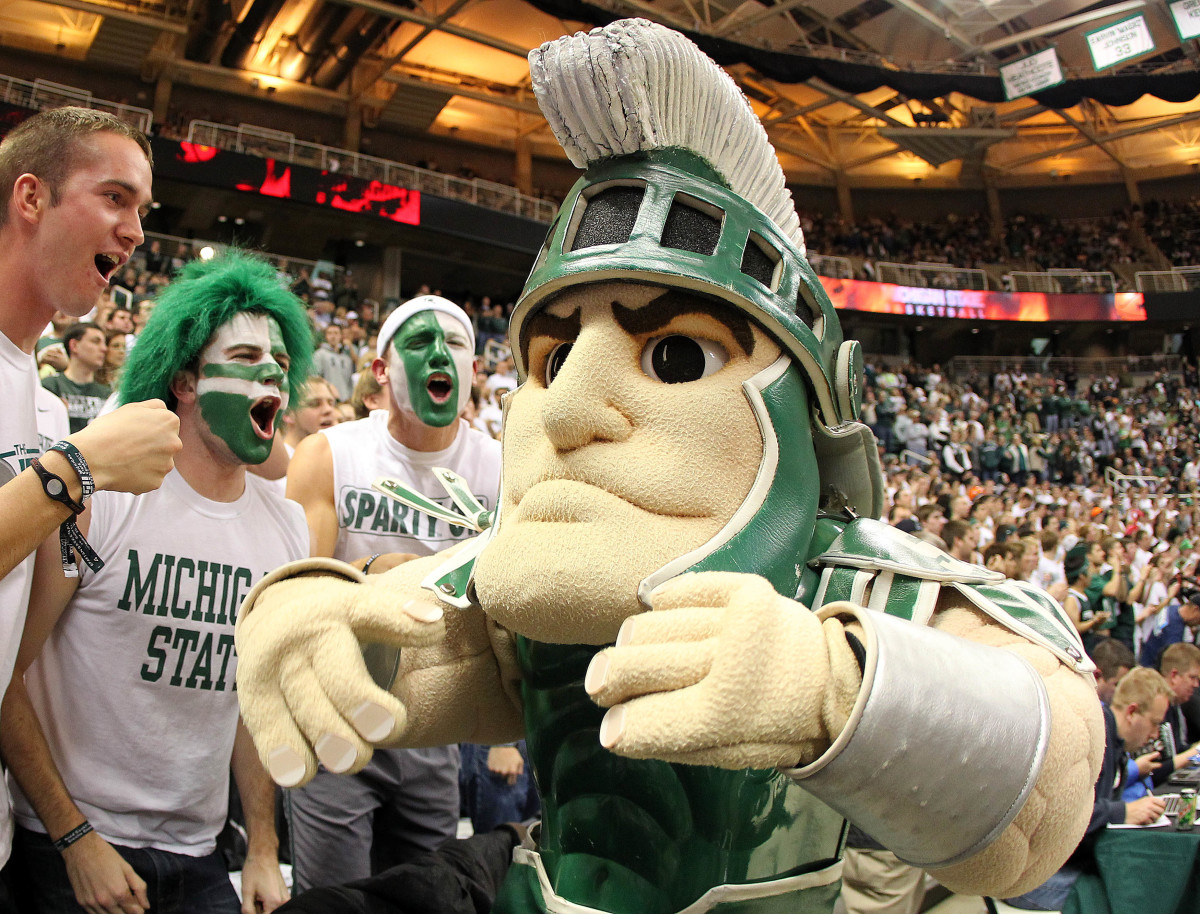 Fans with the Michigan State Spartans mascot before a basketball game.