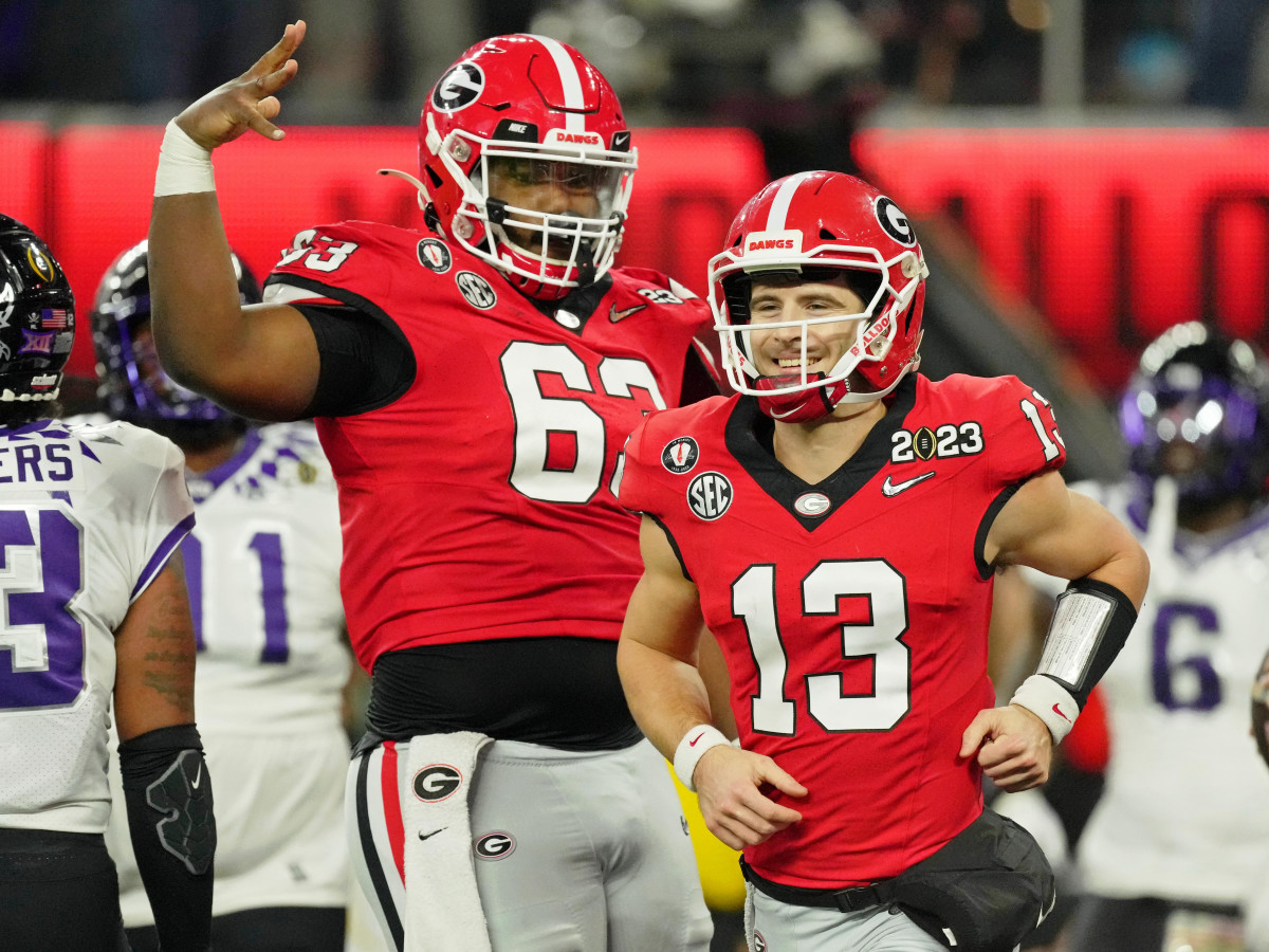Georgia center Sedrick Van Pran, left, celebrates with quarterback Stetson Bennett during the College Football Playoff final against TCU