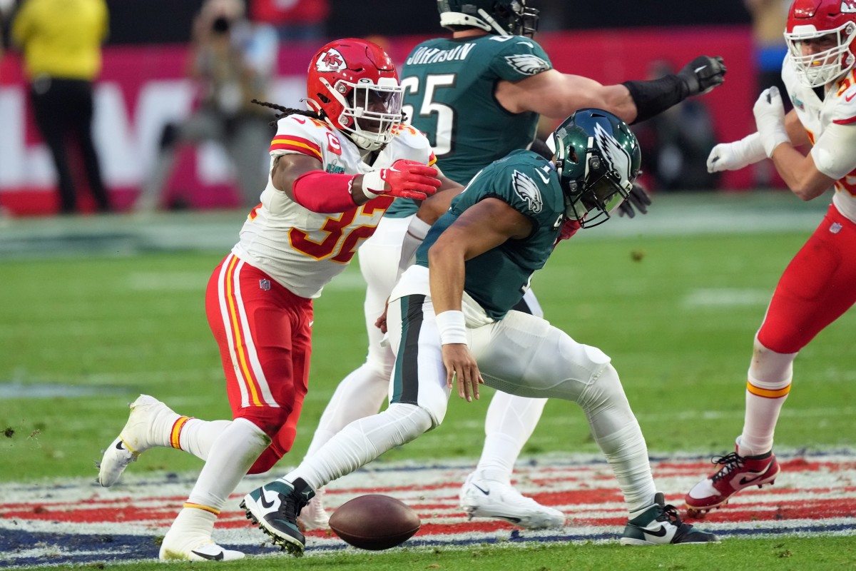 Chiefs linebacker Nick Bolton stripes Eagles quarterback Jalen Hurts, picks up the ball and runs for a touchdown.