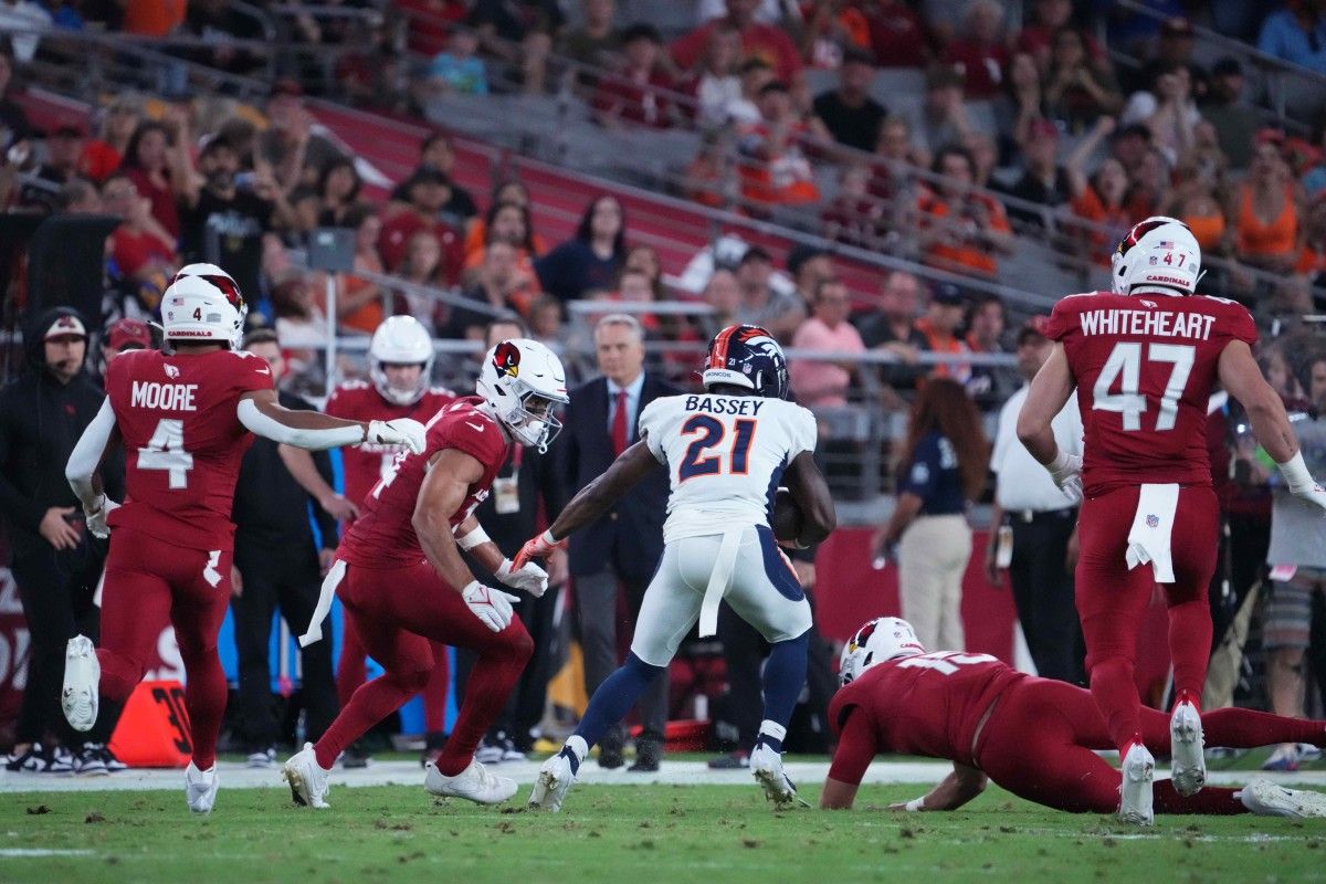 Denver Broncos cornerback K'Waun Williams (21) returns an interception against the Arizona Cardinals during the first half at State Farm Stadium.