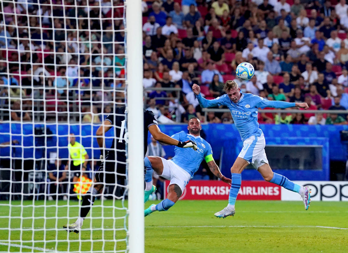 Cole Palmer pictured (right) heading the ball to score for Manchester City in the 2023 UEFA Super Cup final