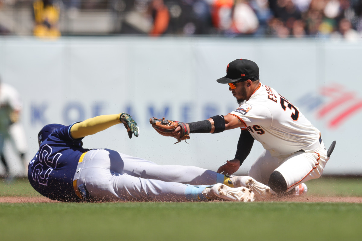 Rays outfielder Jose Siri is tagged out at second base by Giants second baseman Thairo Estrada.