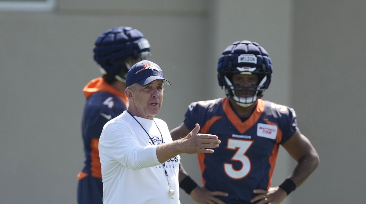 Broncos coach Sean Payton, front left, directs players as quarterback Russell Wilson (3) looks on.