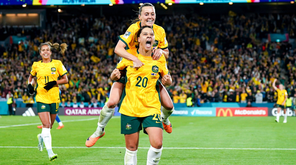 Australia captain Sam Kerr carries teammate Hayley Raso on her back while celebrating Kerr's goal against England in the Women's World Cup semifnals.
