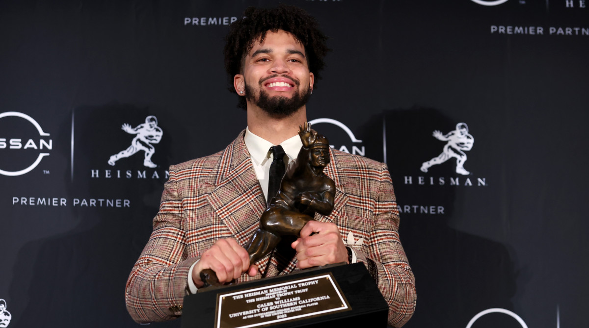 USC quarterback Caleb Williams poses with the Heisman Trophy.