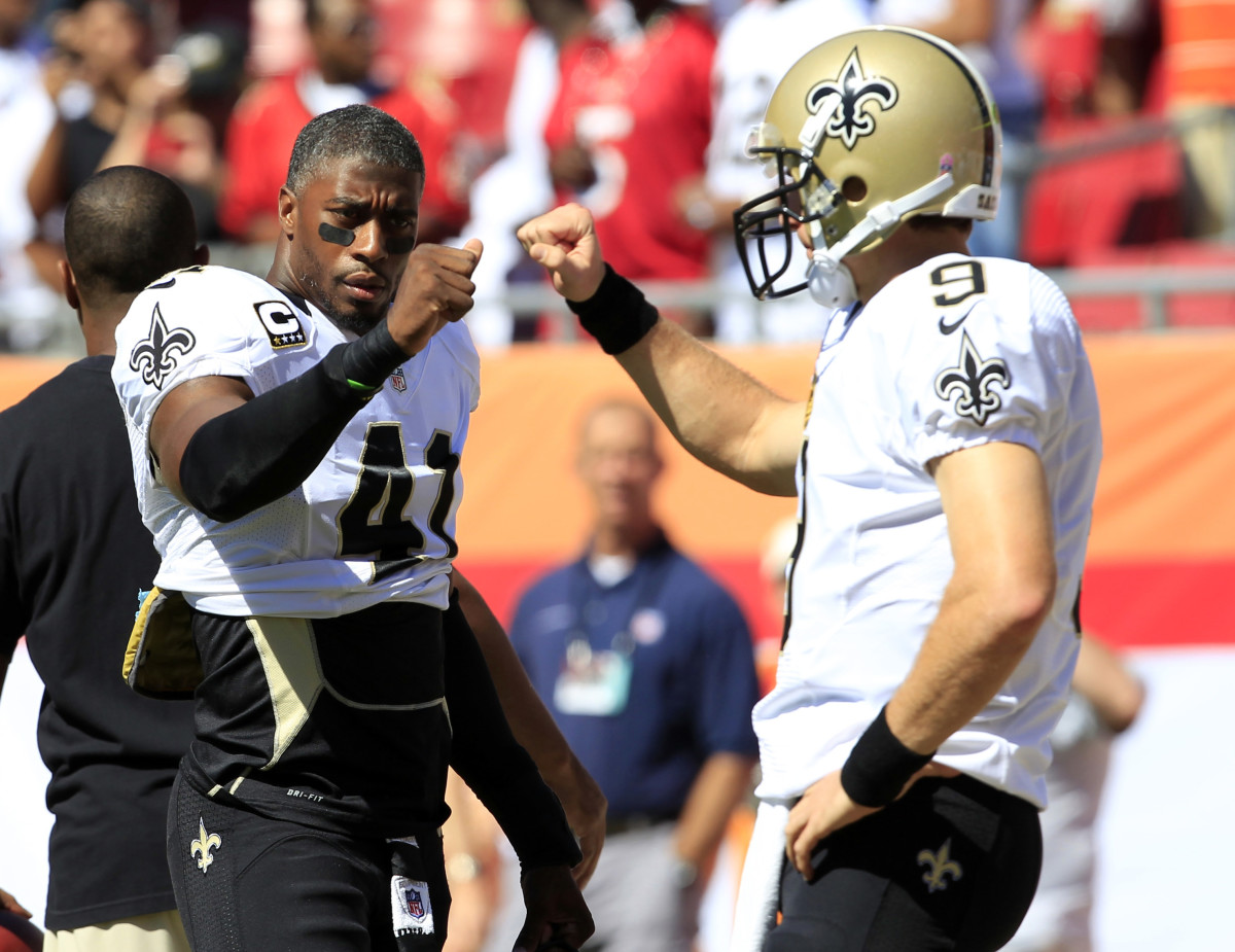 New Orleans Saints safety Roman Harper (41) and quarterback Drew Brees (9) warm up before the game against the Tampa Bay Buccaneers at Raymond James Stadium in 2012.