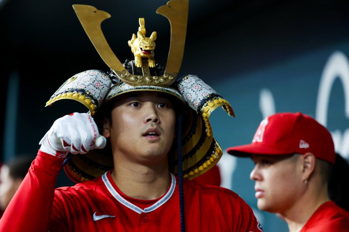 Los Angeles Angels designated hitter Shohei Ohtani celebrates with teammates while wearing a samurai helmet after hitting a home run in the first inning against the Texas Rangers at Globe Life Field Wednesday night.