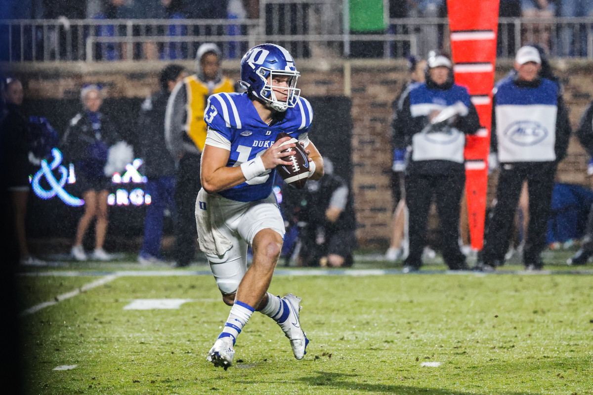 Oct 1, 2022; Durham, North Carolina, USA; Duke Blue Devils quarterback Riley Leonard (13) runs with the ball against the against the Virginia Cavaliers during the first half at Wallace Wade Stadium. Mandatory Credit: Jaylynn Nash-USA TODAY Sports