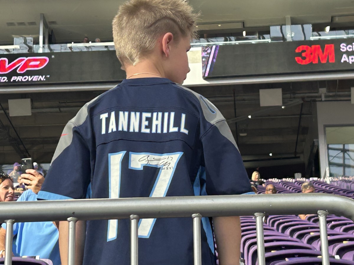 A young Titans fan proudly shows off his newly autographed Ryan Tannehill jersey. (AllTitans.com photo by Tom Brew)