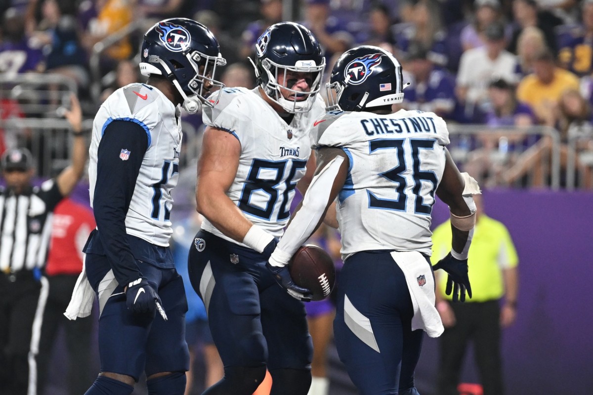 Tennessee Titans running back Julius Chestnut (36) reacts with tight end Trevon Wesco (88) and wide receiver Racey McMath (13) during the fourth quarter against the Minnesota Vikings at U.S. Bank Stadium.