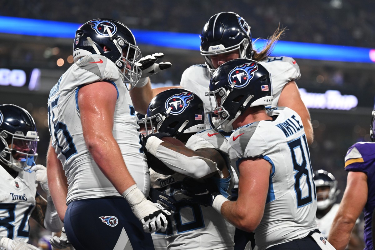 Tennessee Titans running back Julius Chestnut (center) and tight end Josh Whyle (81) and offensive tackle Andrew Rupcich (76) react with teammates after scoring a touchdown against the Minnesota Vikings during the fourth quarter at U.S. Bank Stadium.   