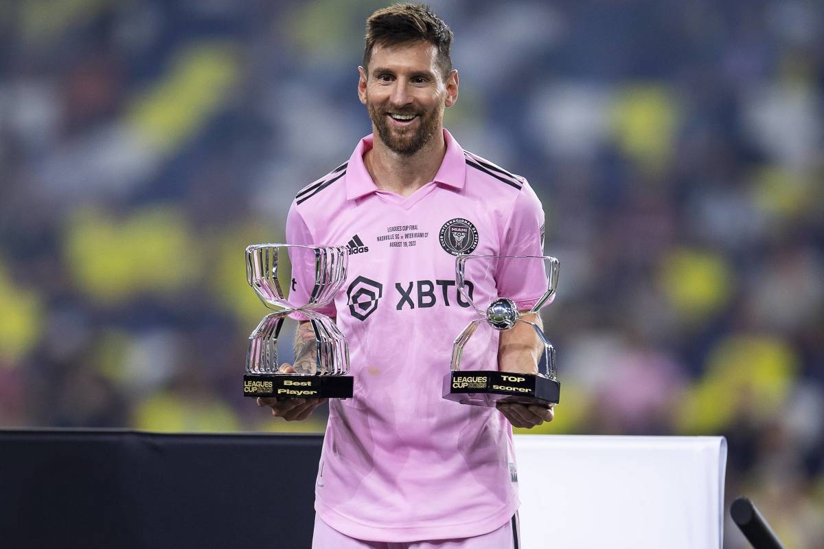 Lionel Messi pictured posing with two individual awards after leading Inter Miami to victory in the 2023 Leagues Cup final