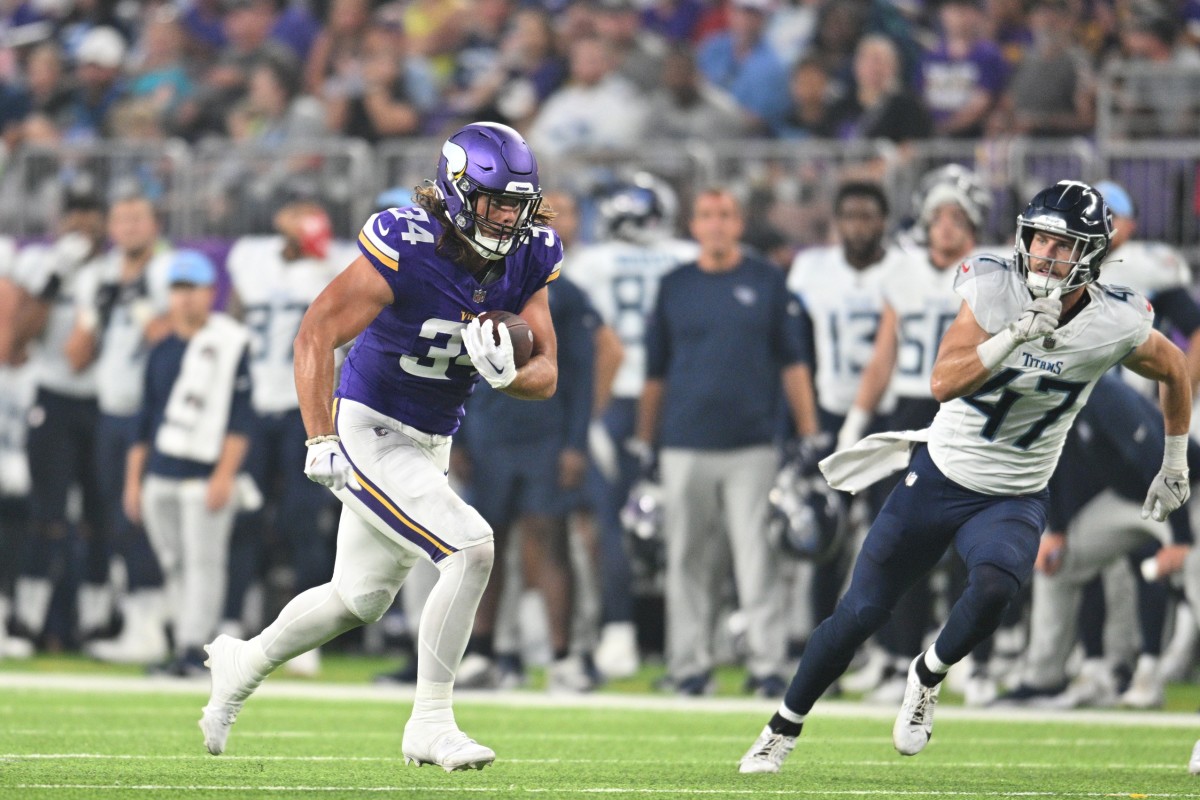 Minnesota Vikings tight end Nick Muse (34) runs after a catch as Tennessee Titans linebacker Ben Niemann (47) looks to make the tackle during the second quarter at U.S. Bank Stadium.