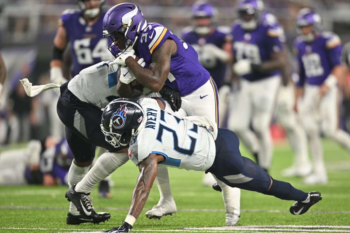 Minnesota Vikings running back DeWayne McBride (37) runs the ball as Tennessee Titans safety Mike Brown (rear) and cornerback Tre Avery (23) make the tackle during the second quarter at U.S. Bank Stadium.