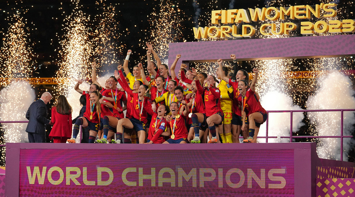 Spain's women's national team celebrates on stage after winning the Women's World Cup.