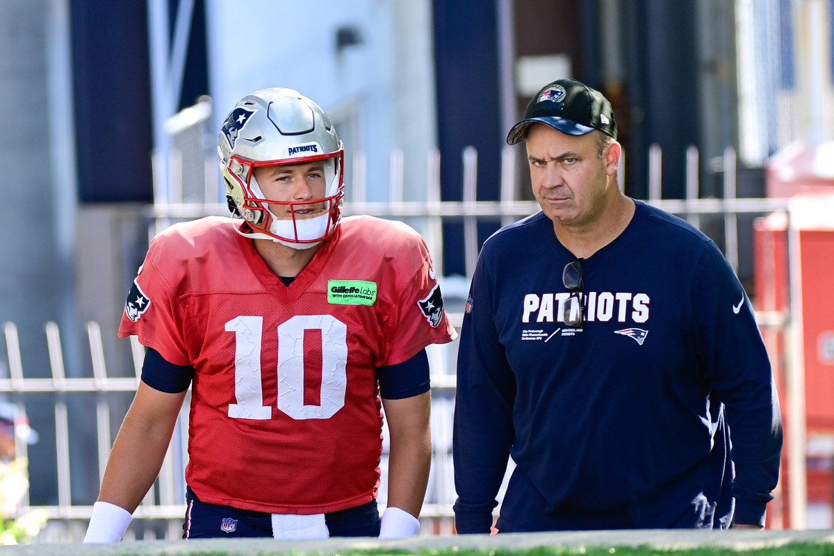 Mac Jones walks next to Bill O’Brien, talking