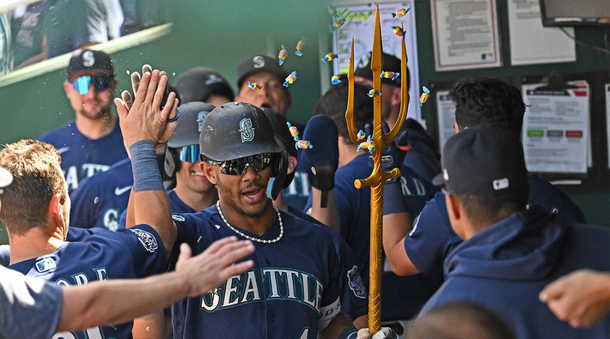 Mariners’ Julio Rodríguez carries the trident to celebrate a home run.