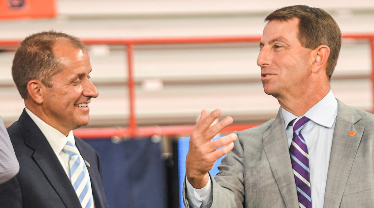 ACC commissioner speaks to Clemson football coach Dabo Swinney.