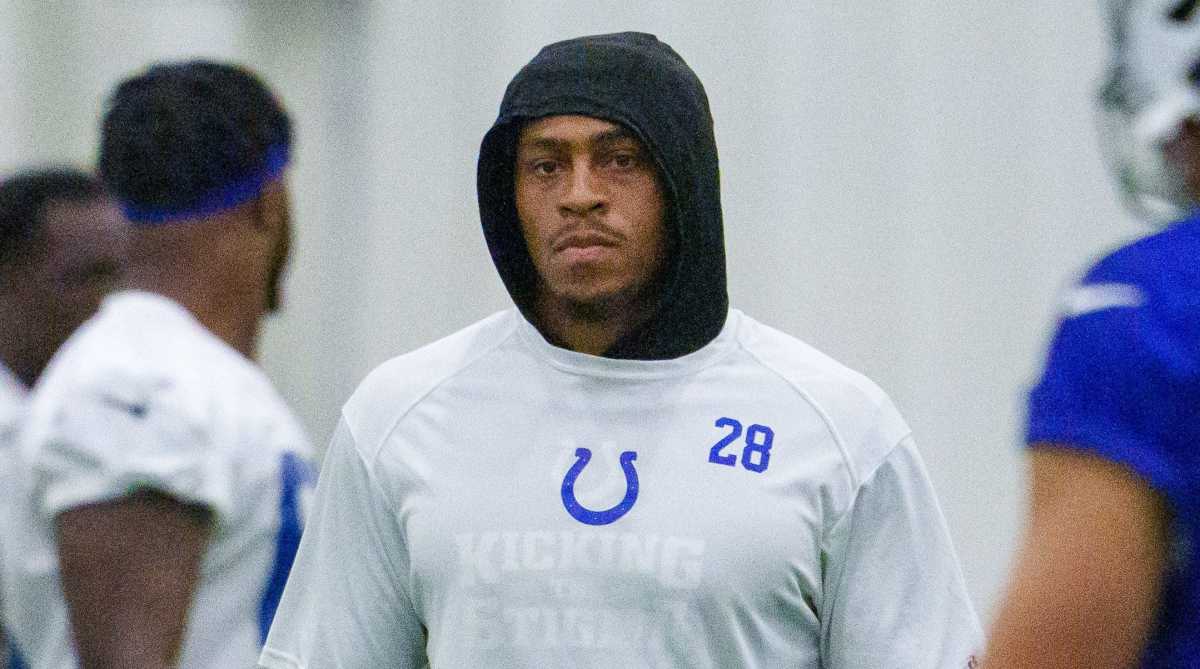 Colts running back Jonathan Taylor walks around training camp without pads and uniform